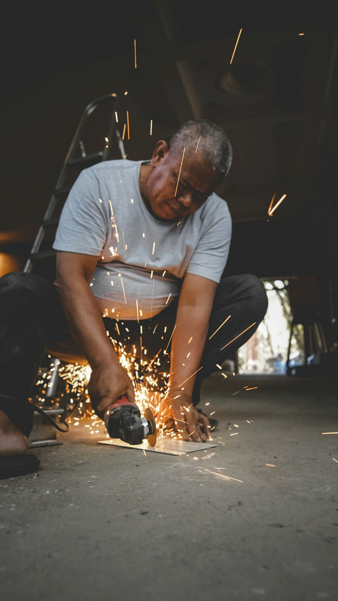 Worker using a grinder with sparks